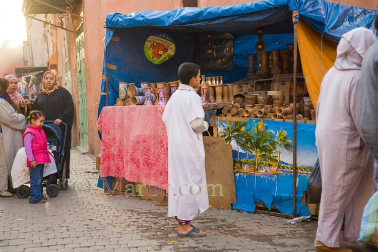 A boy chooses his drum for achoura, in the medina of Marrakesh