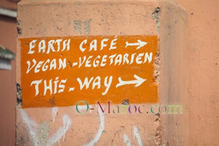 On the walls of the Marrakesh medina, a sign for a vegetarian restaurant