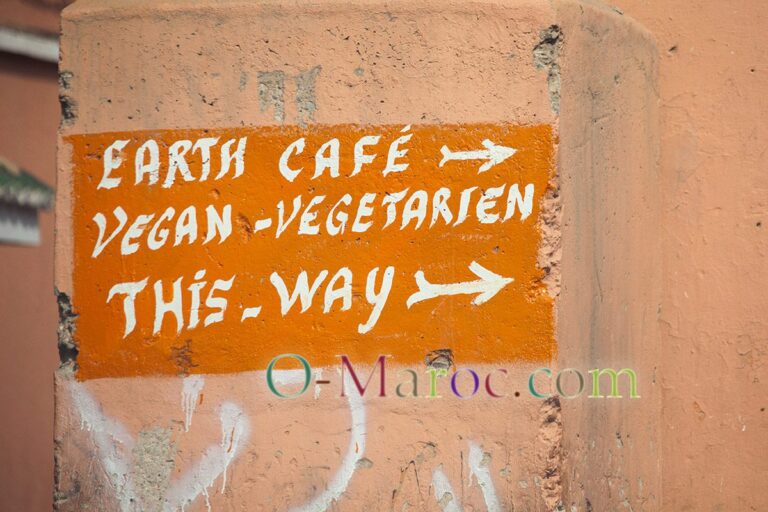 On the walls of the Marrakesh medina, a sign for a vegetarian restaurant