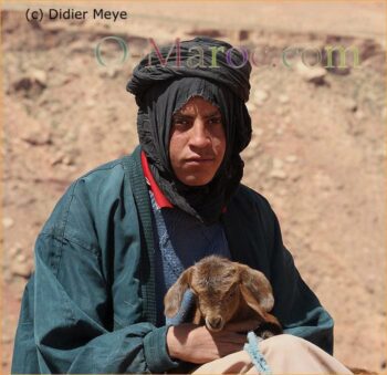 Shepherd holding a young lamb