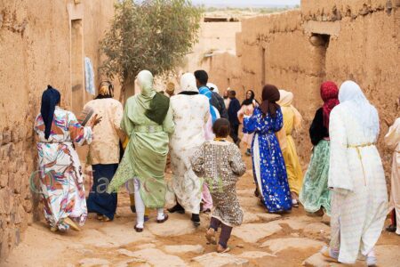 In the cobbled streets of Tissargate, a group of women in festive caftans join the bride from the back.