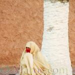Woman in white haïk and red headscarf, Essaouira