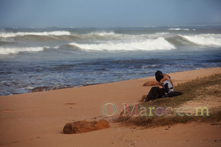 Young Moroccan couple alone on a beach