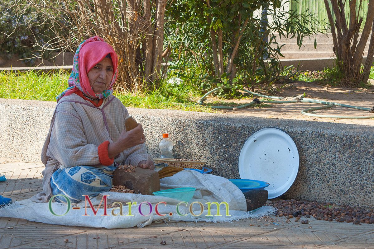 Woman from the cooperative cracking argan nuts