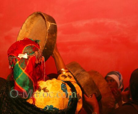 A woman plays a drum at a party
