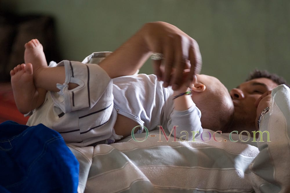 Moroccan man hugging a baby