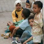 A mother and her children beg in the medina