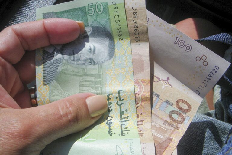 Dirhams in one hand
