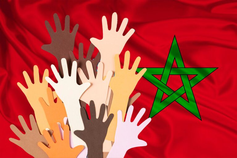Hands on a Moroccan flag symbolise massive solidarity with earthquake victims