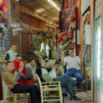 Chairs in front of a store with a TV