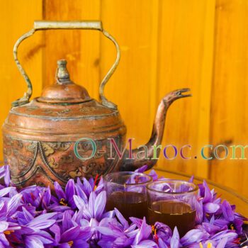 Copper teapot on saffron flowers