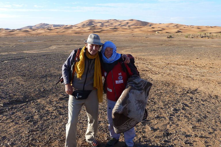 Tourist and guide in the middle of the Moroccan desert