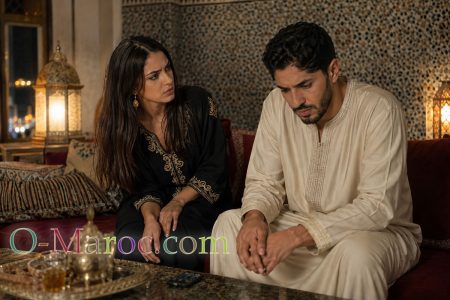 A Moroccan couple at home; the woman asks the man a question, but he avoids her gaze and does not answer her