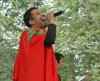 Cheb Kahled sings with a Moroccan flag at the Al Ansra festival in